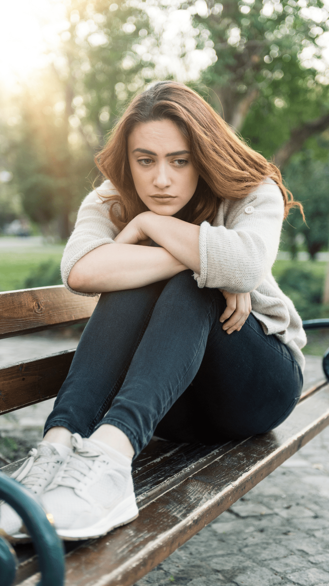 Sad woman sitting on bench