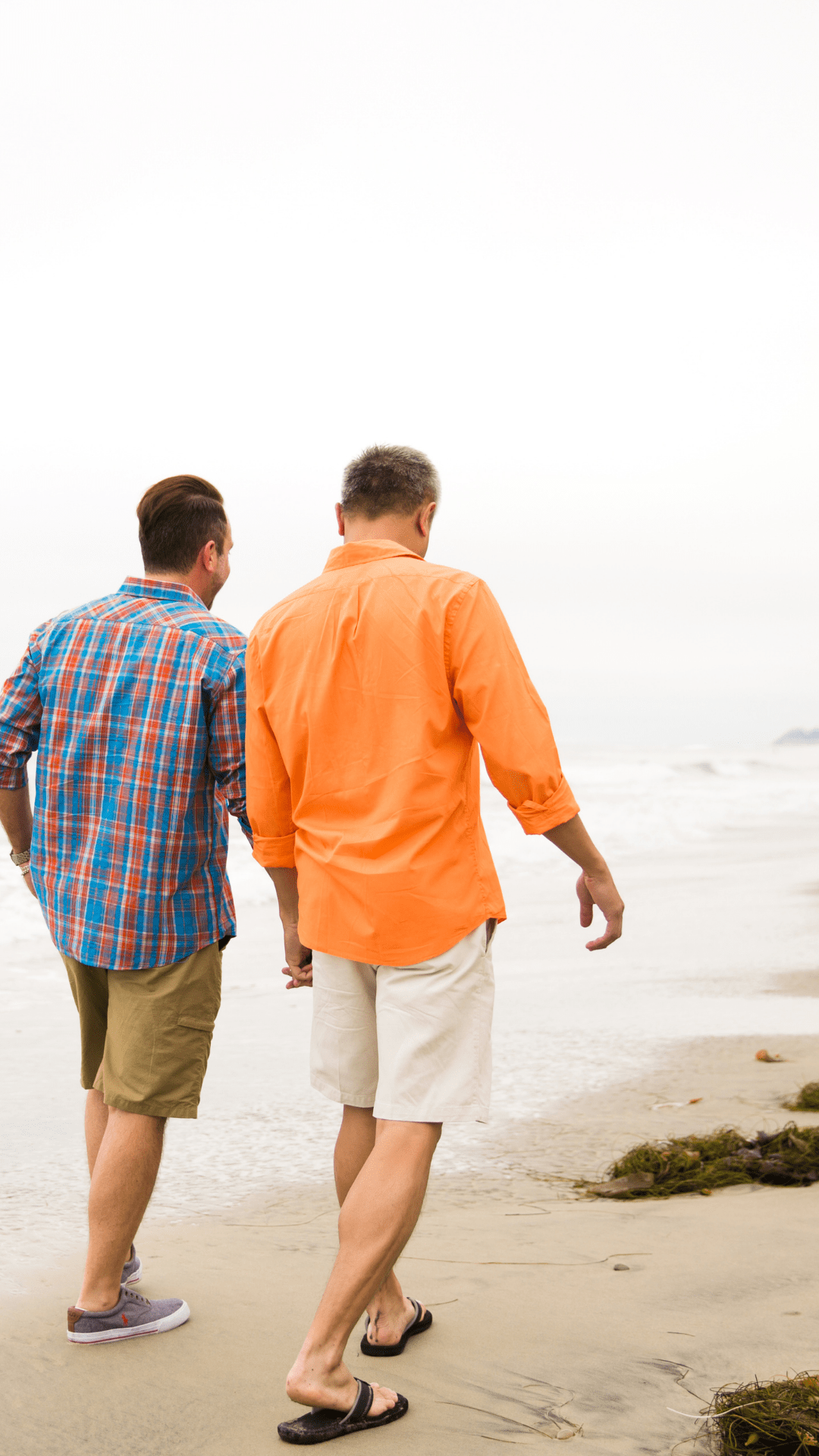 Same sex couple walking on beach